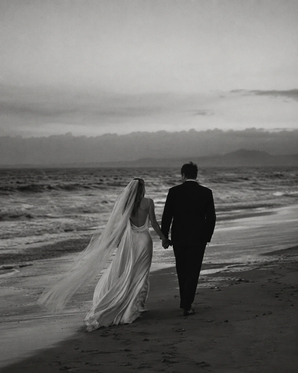Illustrative placeholder of a couple walking beside the sea